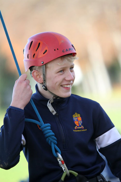 Student in helmet and harness on field day